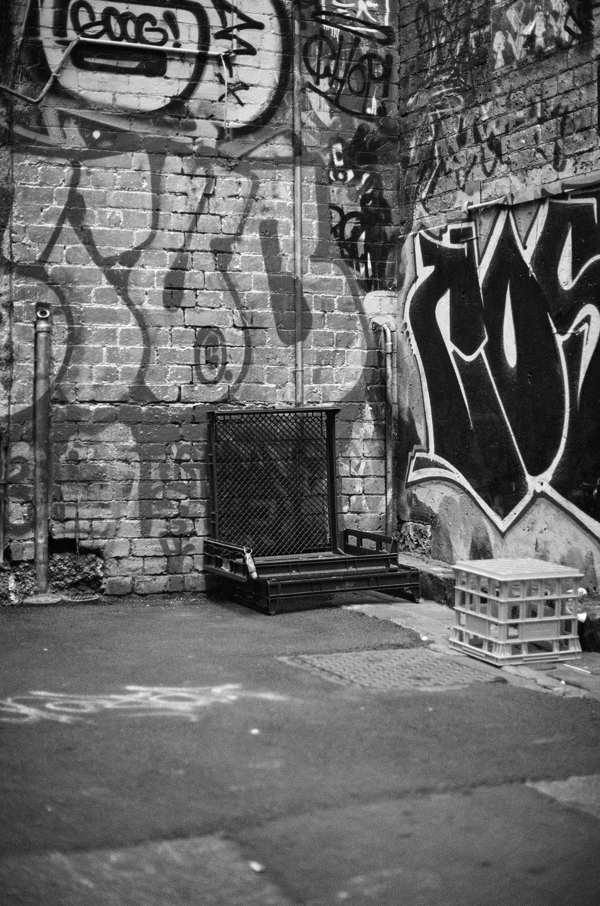 Back alleyway plastic bread crates, arranged to be like a chair